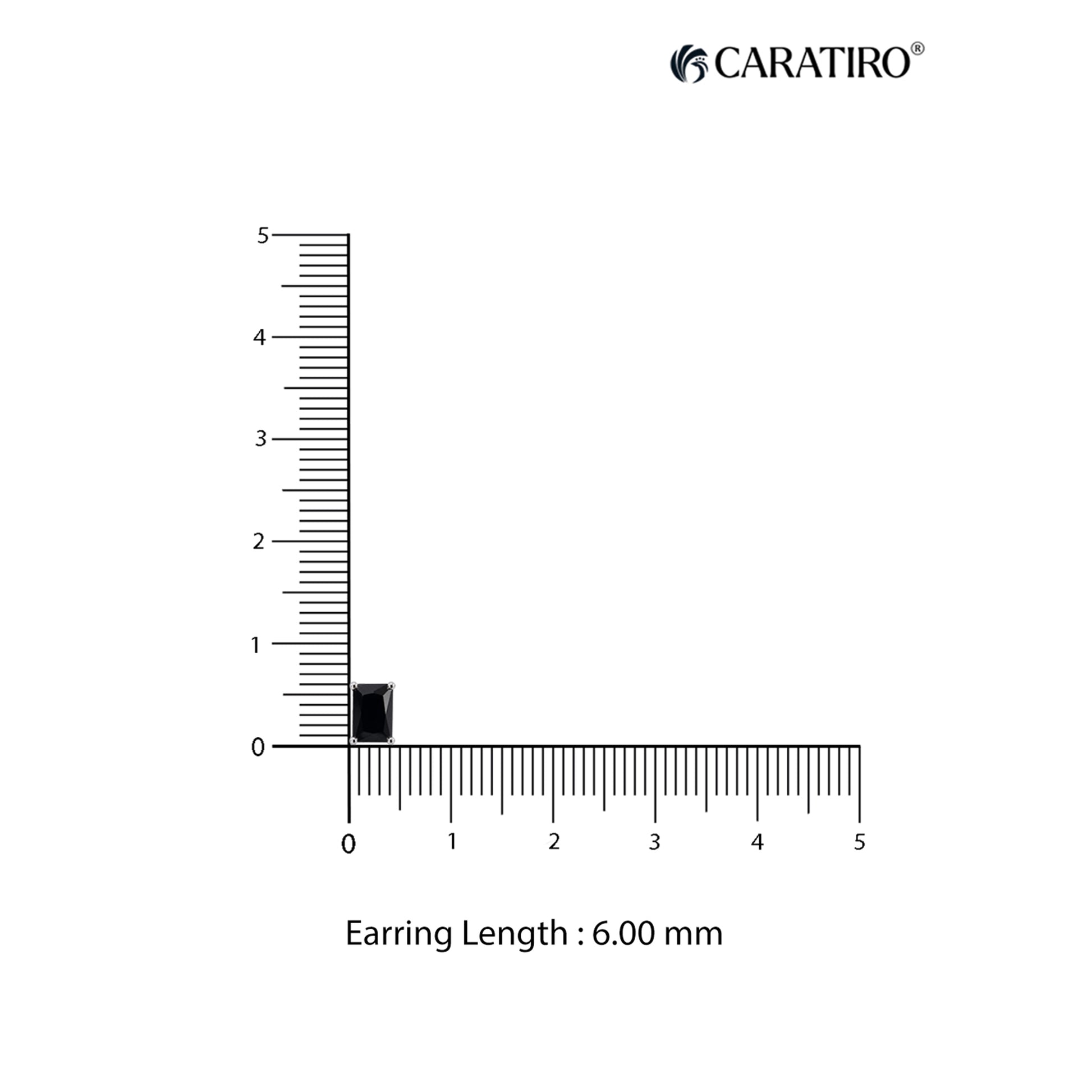 Measurement of an earring length with a ruler on a white background