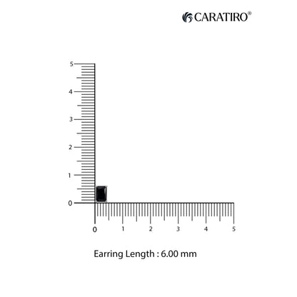 Measurement of an earring length with a ruler on a white background
