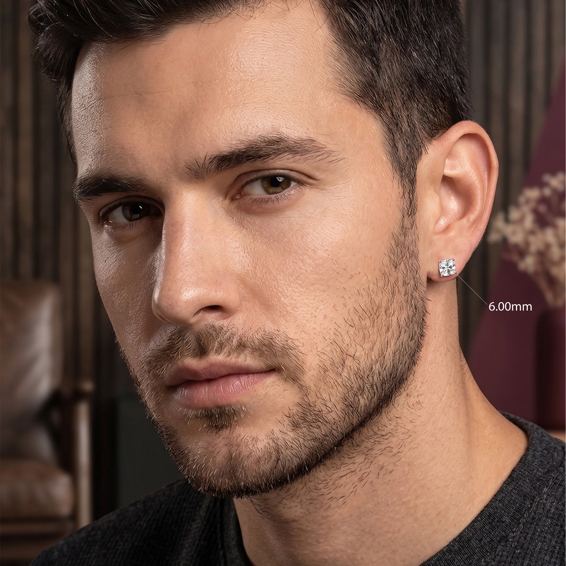 Close-up of a man wearing a diamond earring with a blurred background