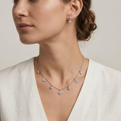 Woman wearing a silver necklace and earrings 