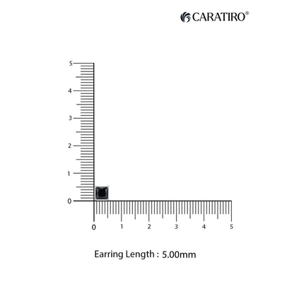 Measurement of an earring length with a ruler on a white background