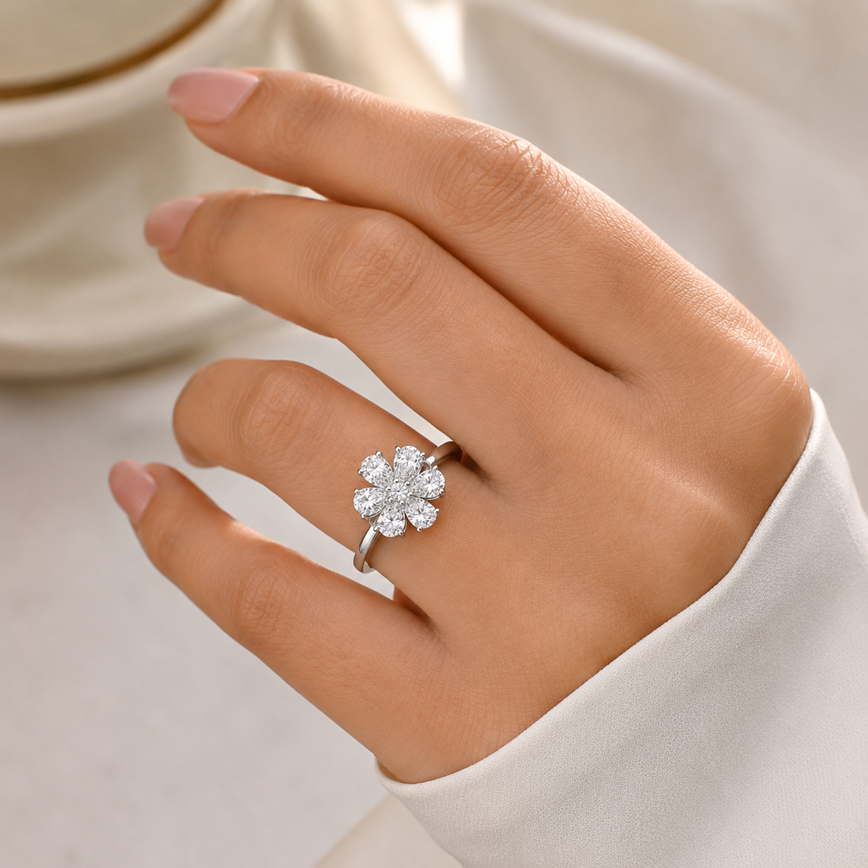 close-up of a hand wearing a silver-toned flower ring 