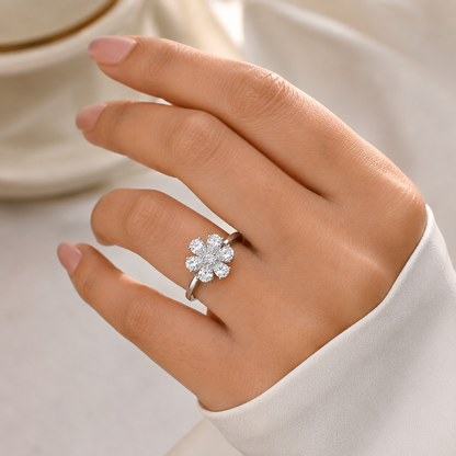 close-up of a hand wearing a silver-toned flower ring 
