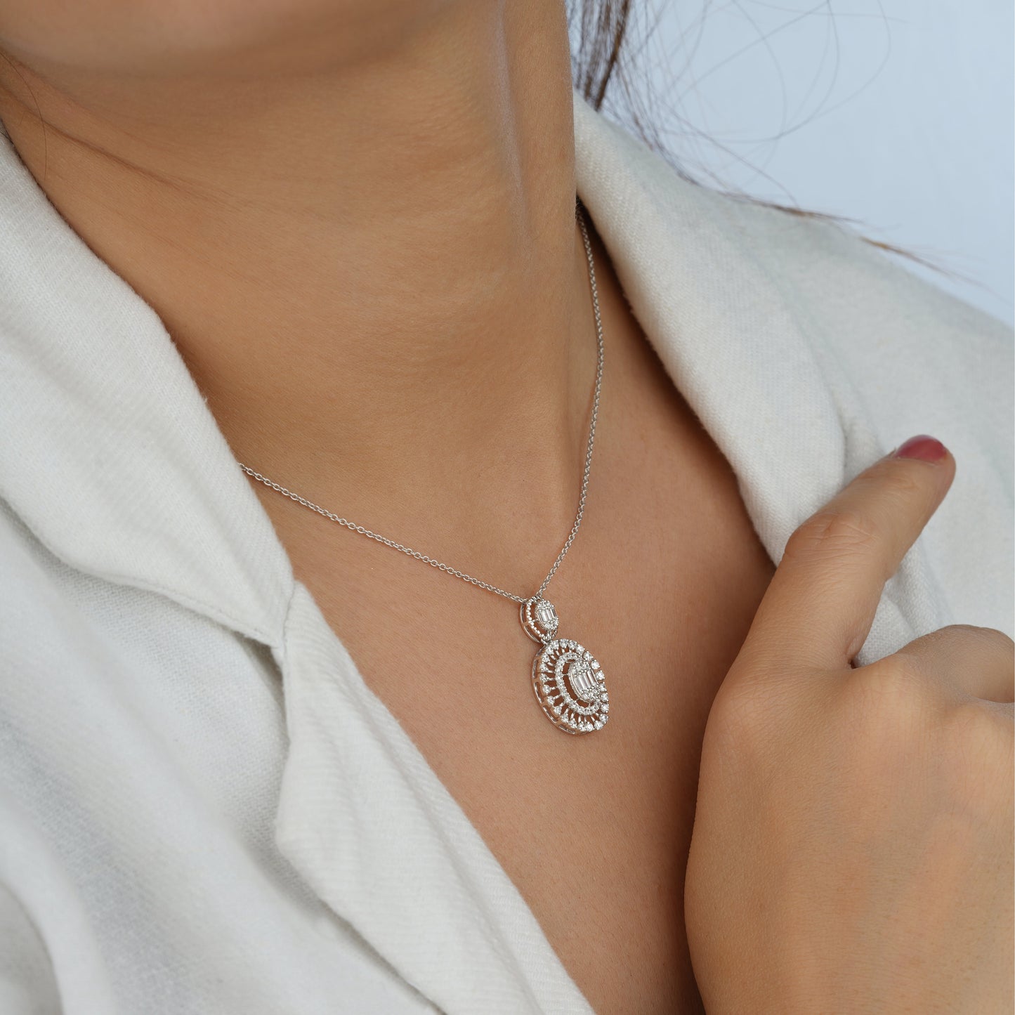 Silver necklace with a pendant worn by a person