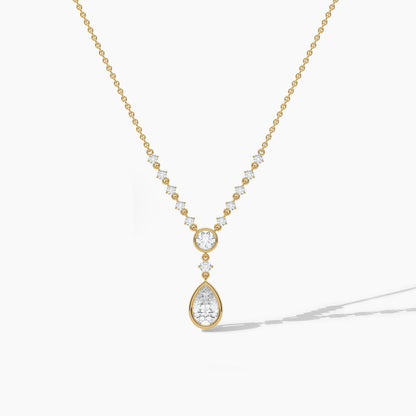 Gold necklace with a teardrop-shaped pendant on a white background