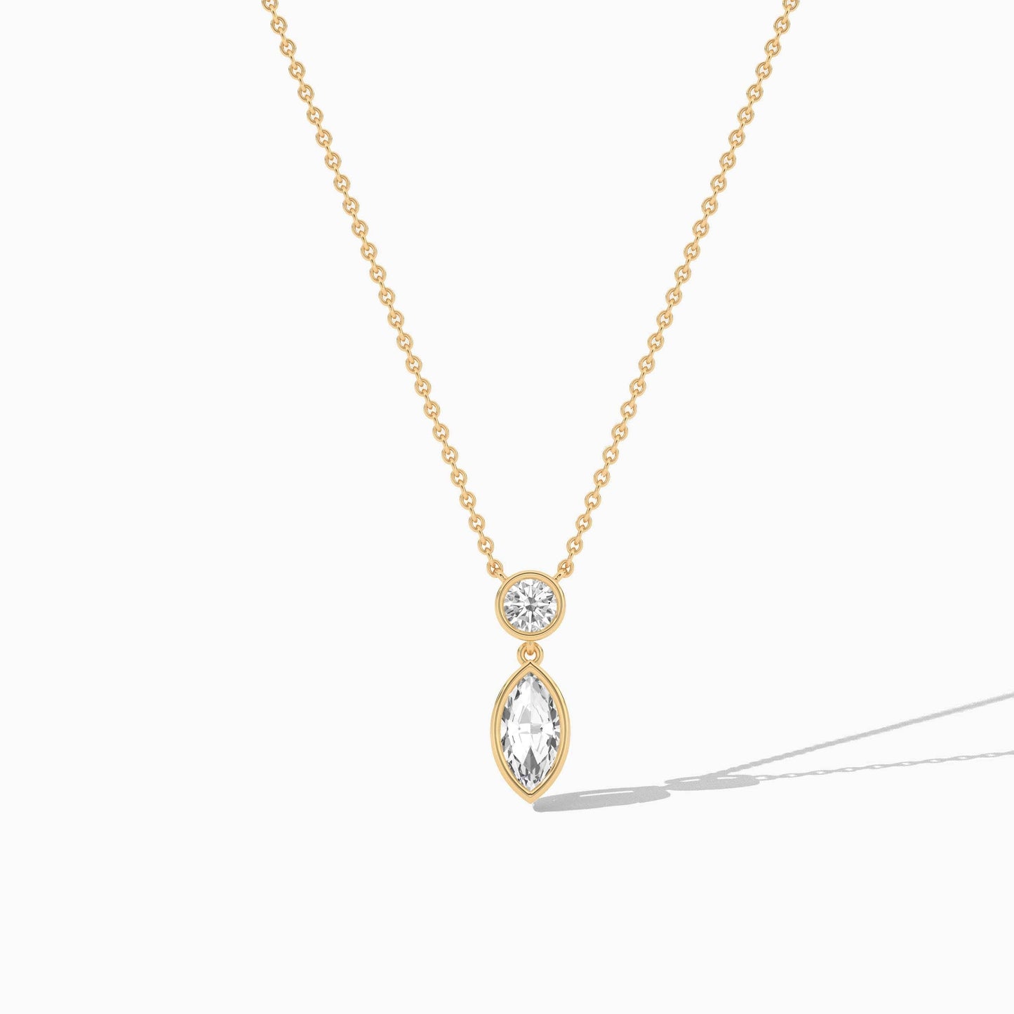 Gold necklace with a teardrop-shaped pendant on a white background