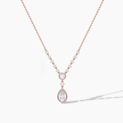 Rose gold necklace with a teardrop-shaped pendant on a light gray background