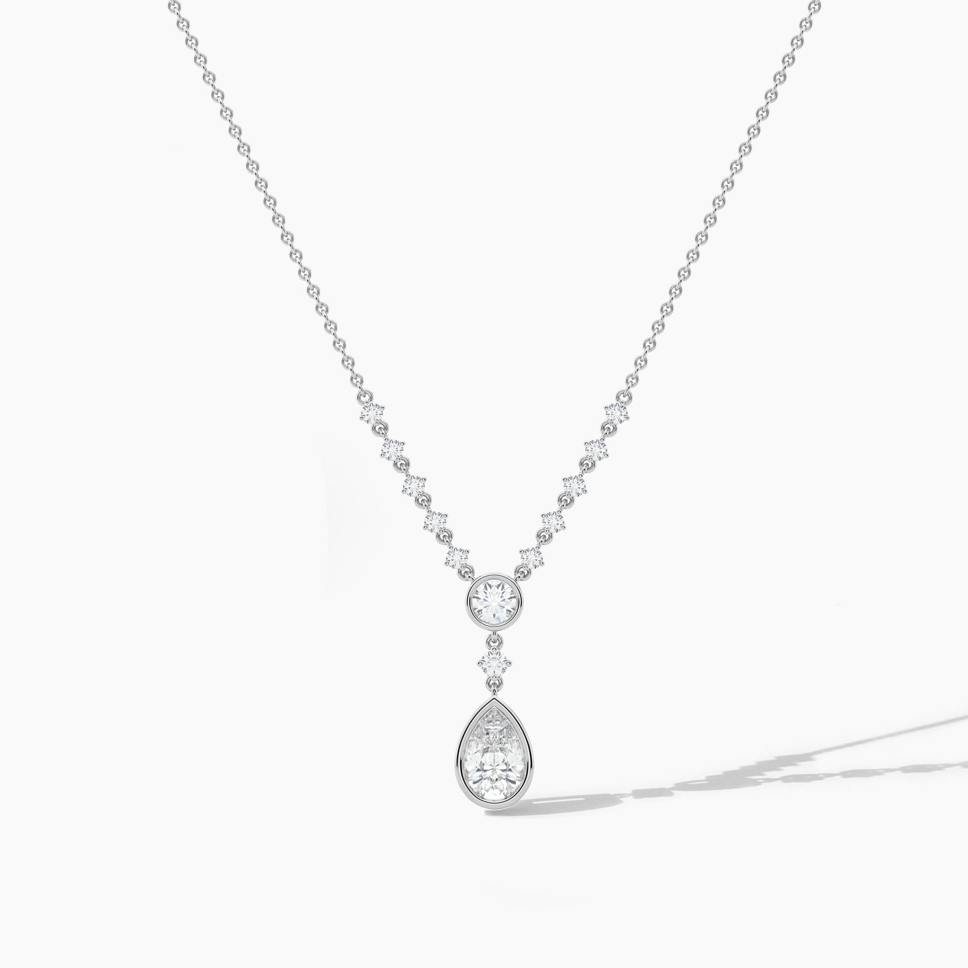 Silver necklace with a teardrop-shaped pendant on a white background