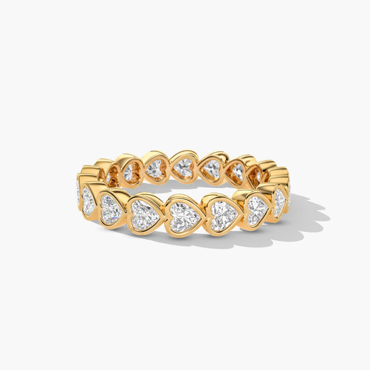 Gold ring with heart-shaped diamond stones on a white background
