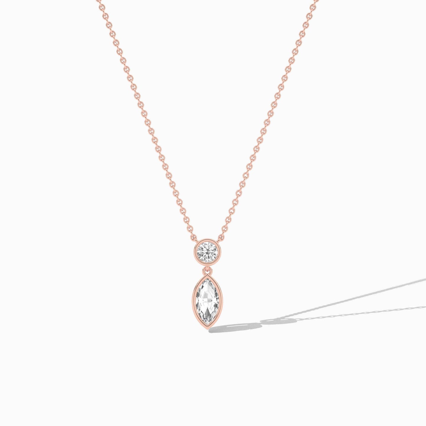 Rose gold necklace with a teardrop-shaped pendant on a white background