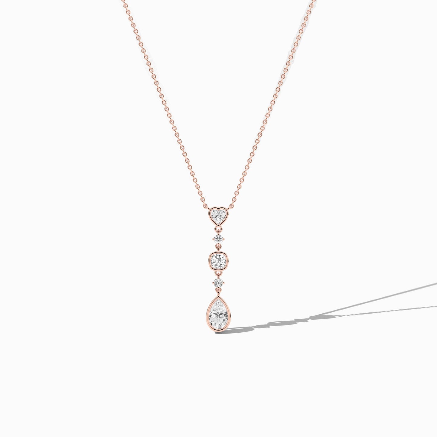 Rose gold necklace with a pendant on a white background