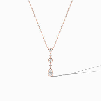 Rose gold necklace with a pendant on a white background