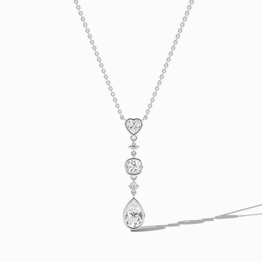 Diamond necklace with heart and teardrop pendants on a white background