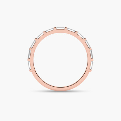 Rose gold ring with a white stone on a light beige background
