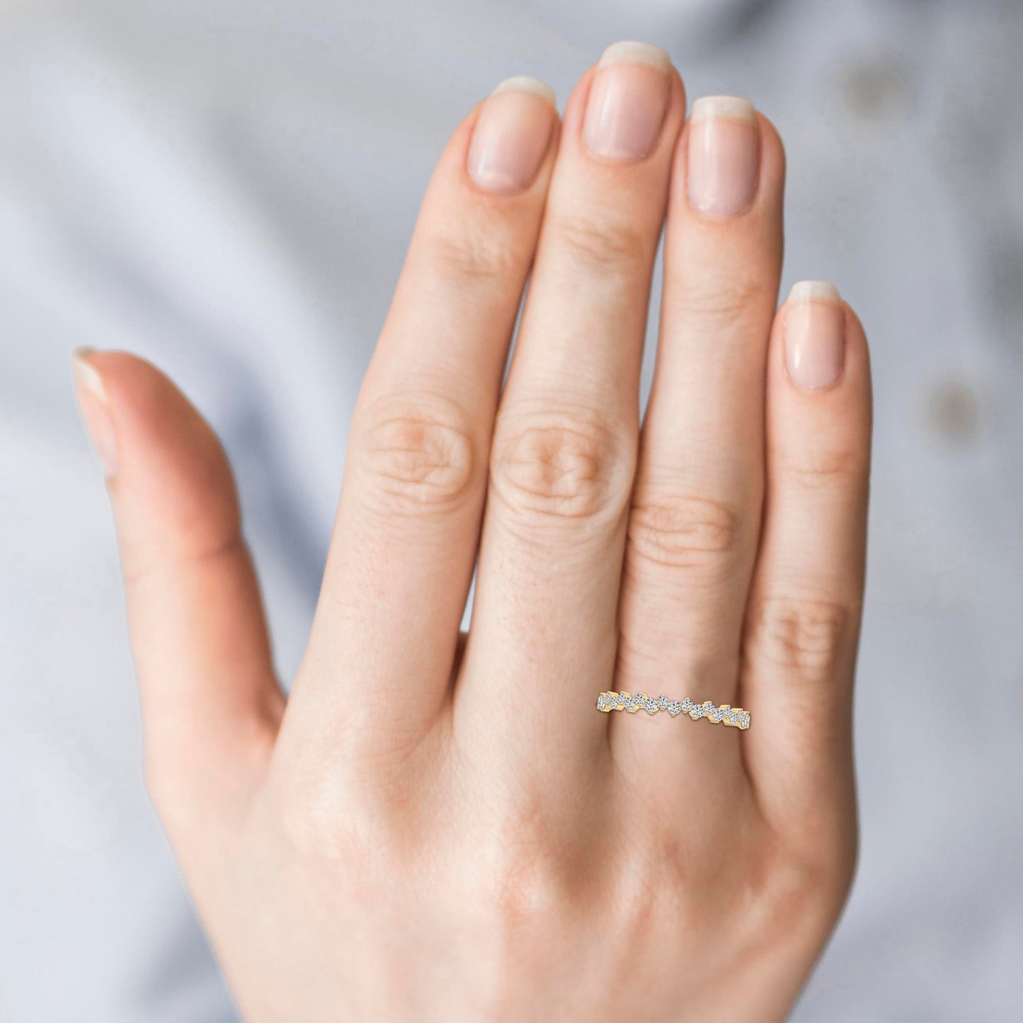 Hand wearing a diamond ring 