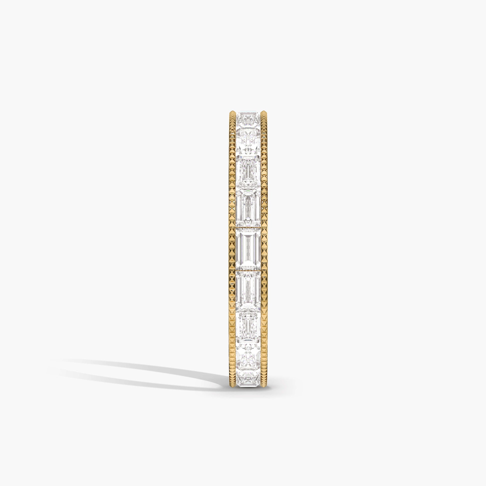 Gold and diamond eternity ring on a white background