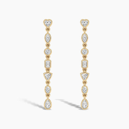 Gold earrings with clear gemstones on a white background
