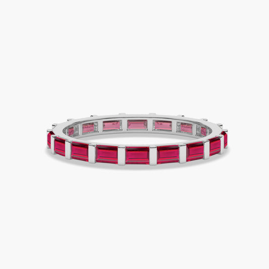 Silver ring with pink gemstones on a white background