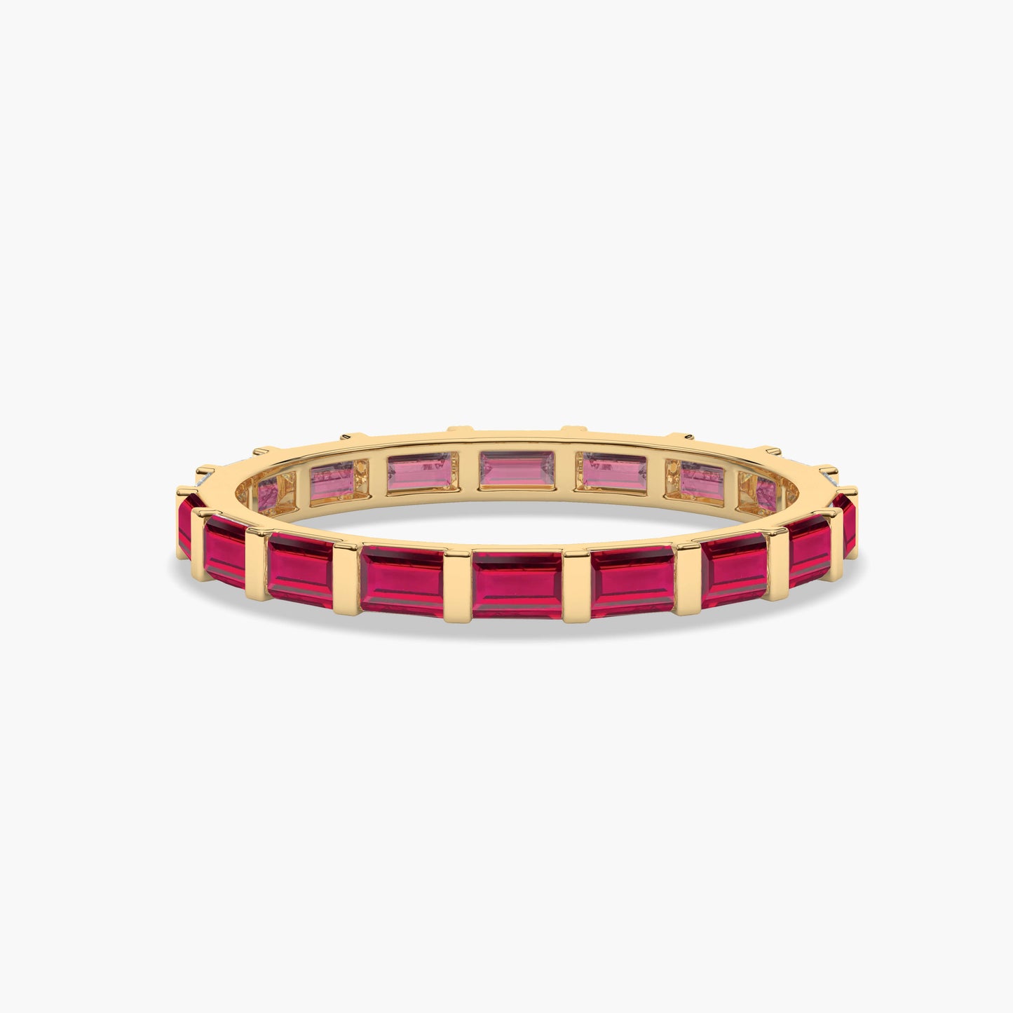 Gold ring with red gemstones on a white background