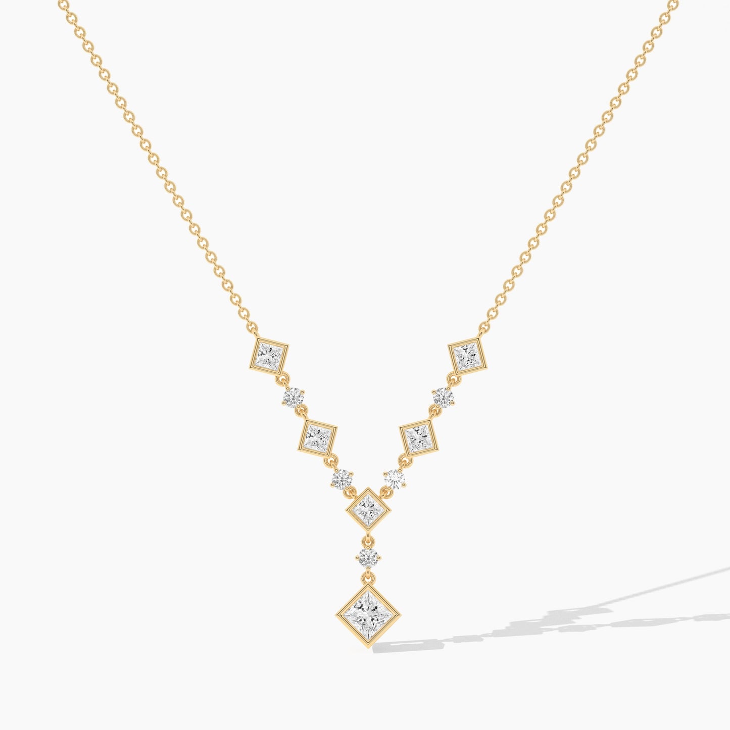 Gold necklace with diamond pendants on a white background
