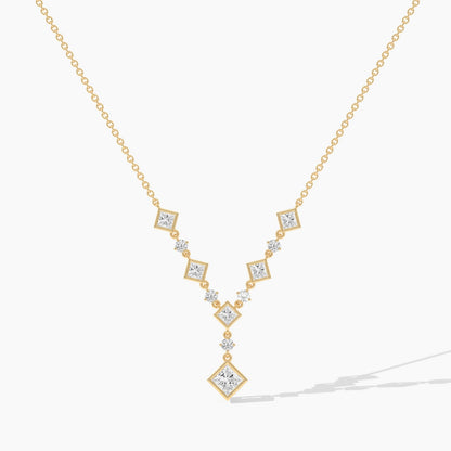 Gold necklace with diamond pendants on a white background