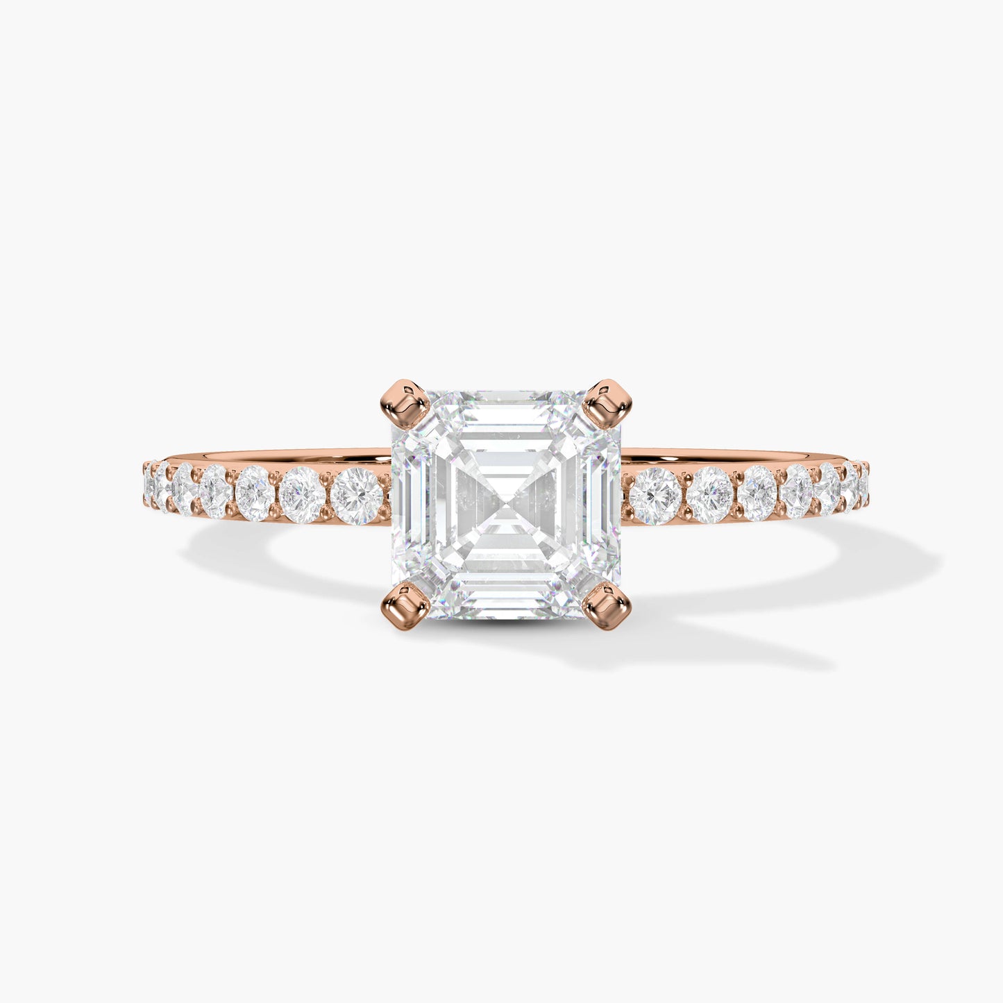 Rose gold ring with a large diamond and smaller diamonds on the band against a white background